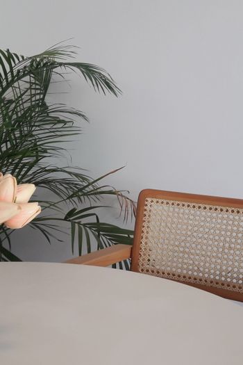 cane chair placed next to a round table
